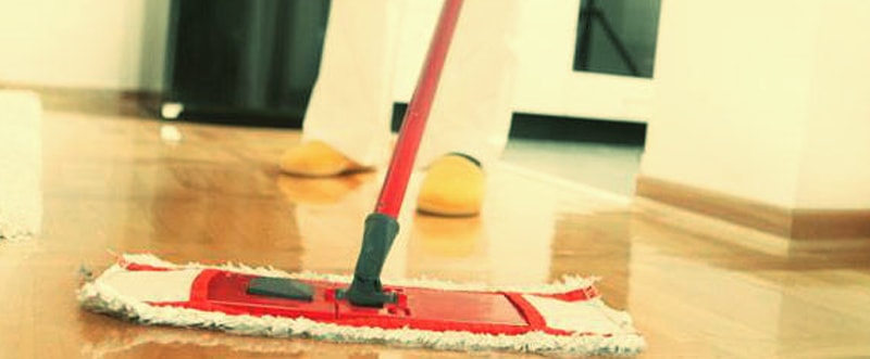 cropped image of a man wiping hardwood floor