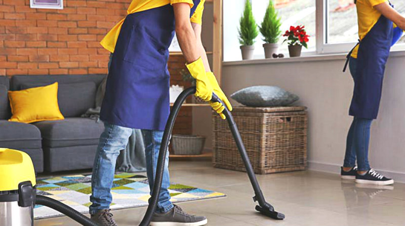 cropped image of man and woman vacuuming and wiping a room