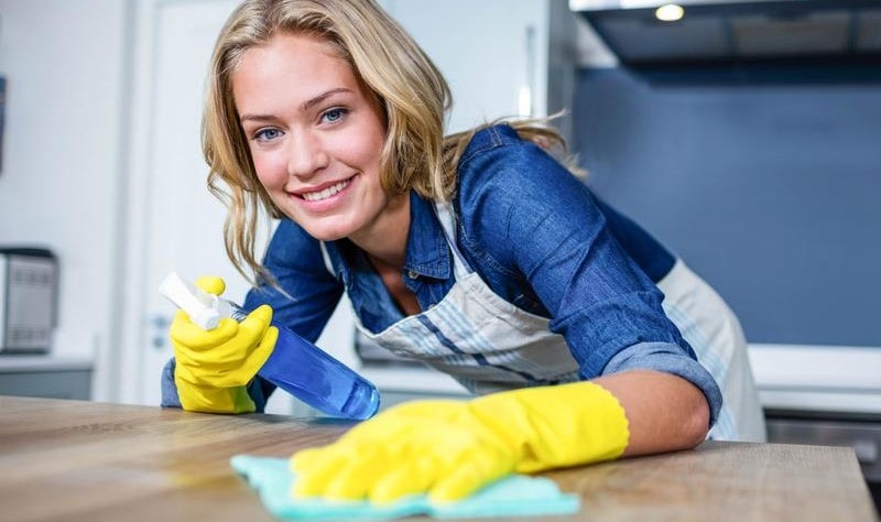 young professional disinfecting a surface