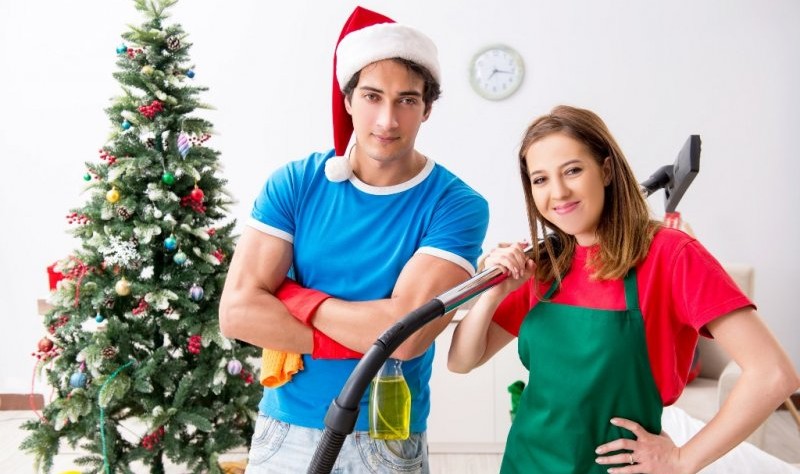 young couple preparing to spruce up a house for christmas
