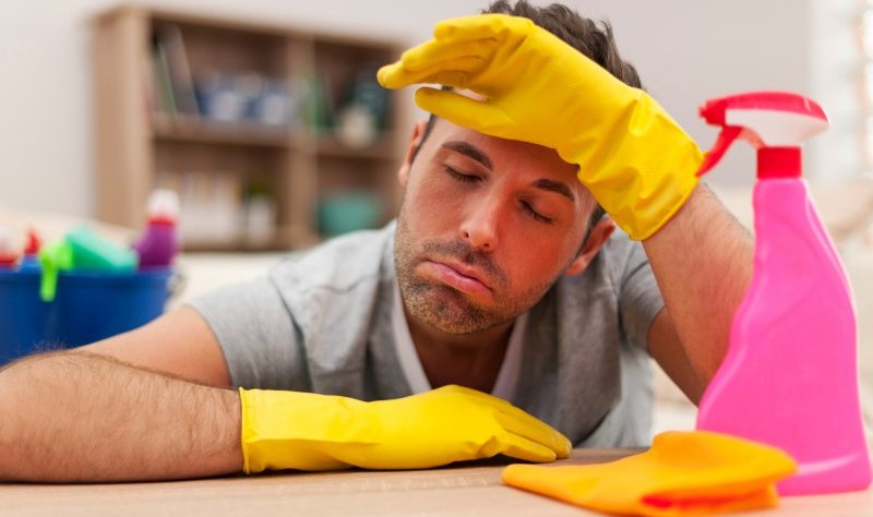 young man looking stressed while sprucing up a house