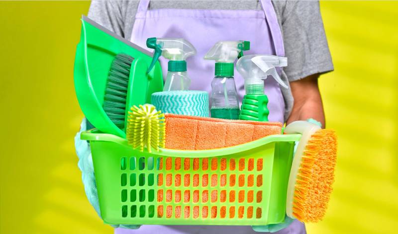 Men standing with cleaning tools