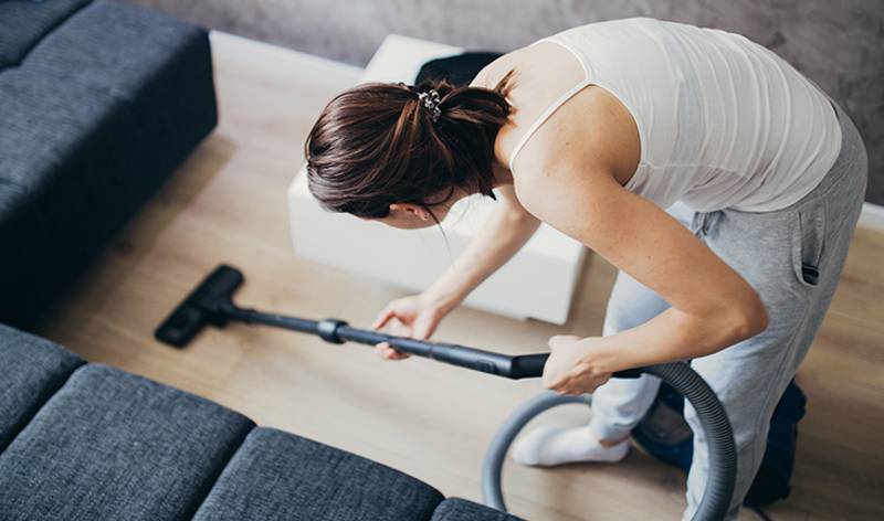 Women vacuum to clean floor