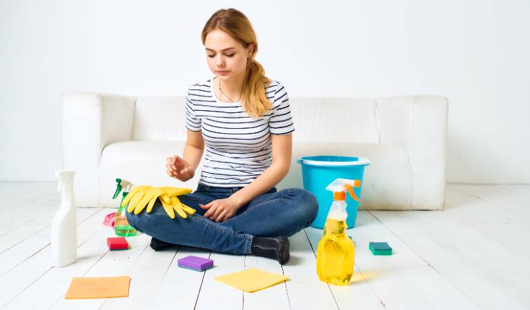 woman sitting on floor with different products and tools