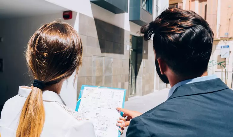 couple inspecting a building before renting
