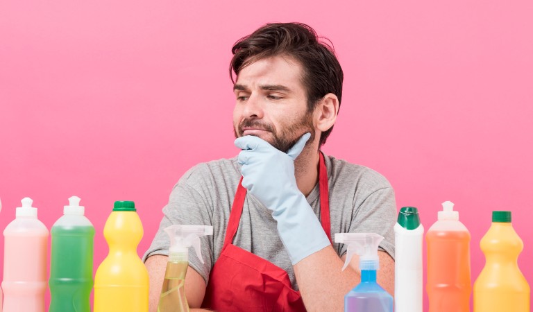 young man looking confused while choosing a cleaner