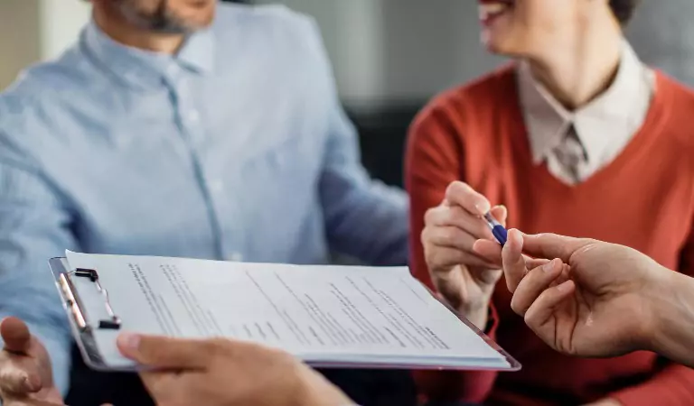cropped picture of a couple with a lease contract