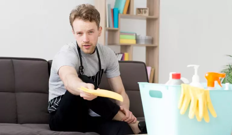 young man with some cleaning supplies is ready to clean