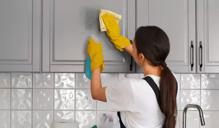 young woman wiping a surface with a cloth mop
