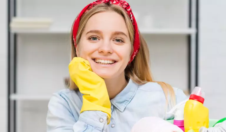 young woman with some cleaning products ready to clean