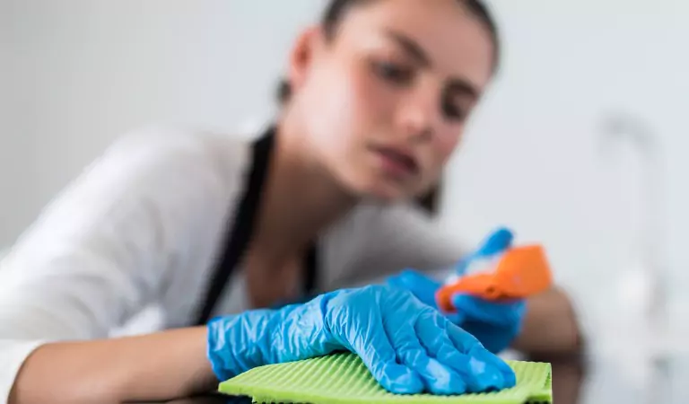young woman wiping a surface with a cloth mop