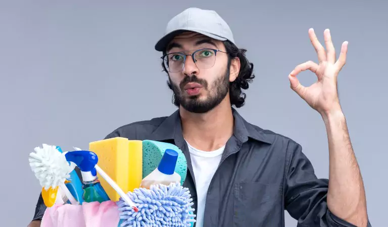 young man with a bucket full of cleaning supplies