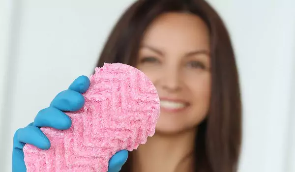 woman holding a magic eraser in her hand