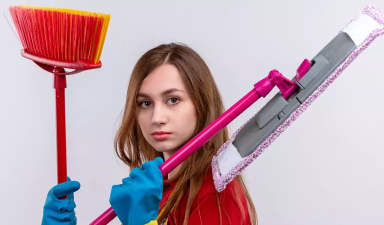 woman with some cleaning essentials posing for a picture