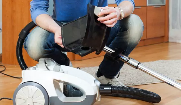 cropped picture of a person with a vacuum cleaner