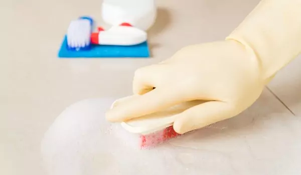 cropped picture of a person cleaning with soapy water