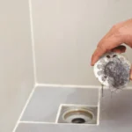 Clogged pipe antiodor strainer with foulsmelling garbage in the bathroom