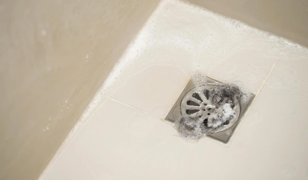 Waste hair fragments cause clogged pipe in the bathroom
