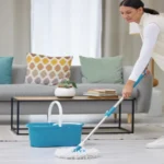 Woman mop and smile on cleaning floor with home for hygiene housekeeping