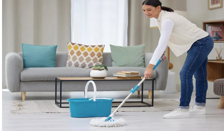 Woman mop and smile on cleaning floor with home for hygiene housekeeping