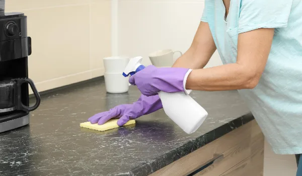 Mature woman cleaning kitchen